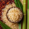 Close-up view of Bamboo Rice grains, highlighting their unique texture and vibrant color on a rustic wooden surface.